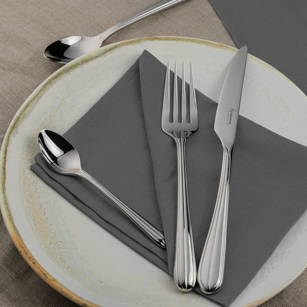 44 Piece Cutlery Set for 6 People Luma 44BXLUM-IGLC Grunwerg Modern stainless steel cutlery on a restaurant dining table