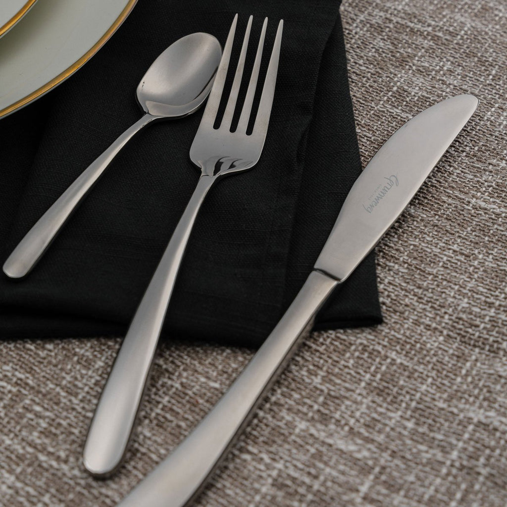 56 Piece Cutlery Set for 8 People Samba 56BXSMB-IGLC Grunwerg Elegant stainless steel cutlery on a restaurant dining table